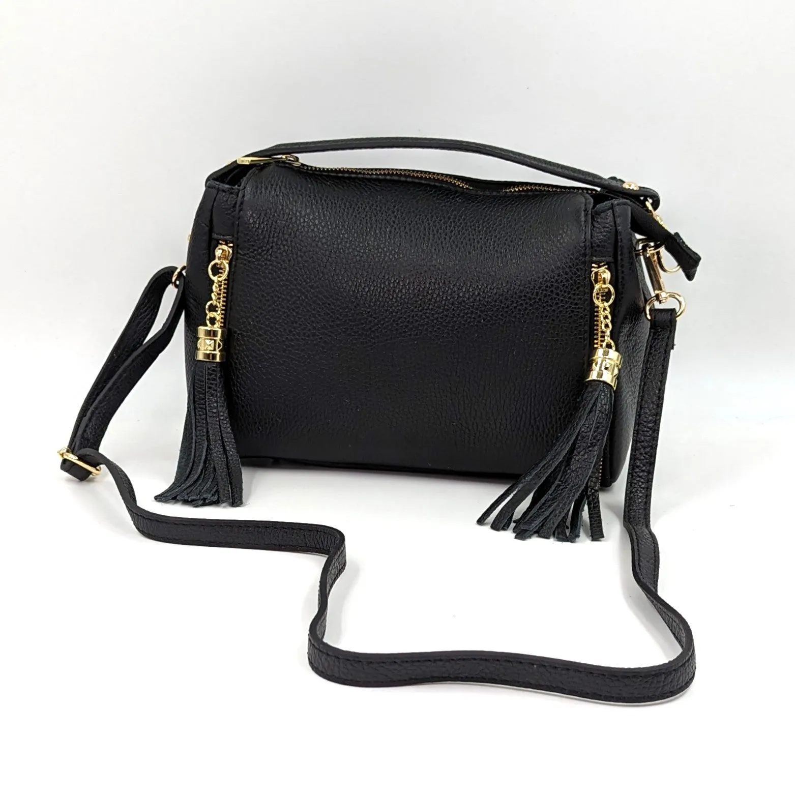 Smallish barrel style leather handbag with tassel elements on sides
